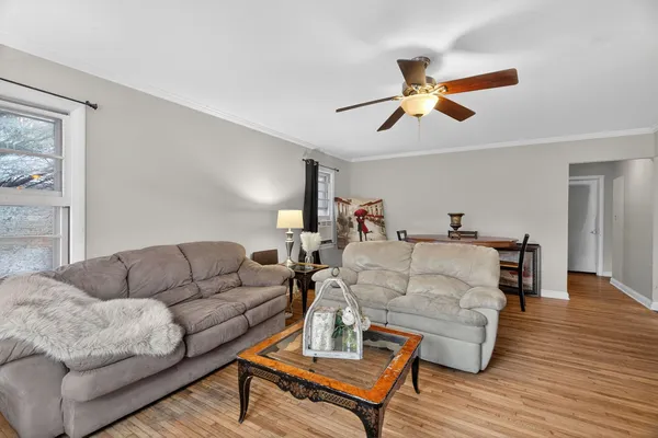 a living room with furniture and a wooden floor