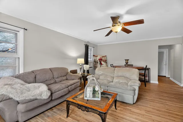 a living room with furniture and a wooden floor