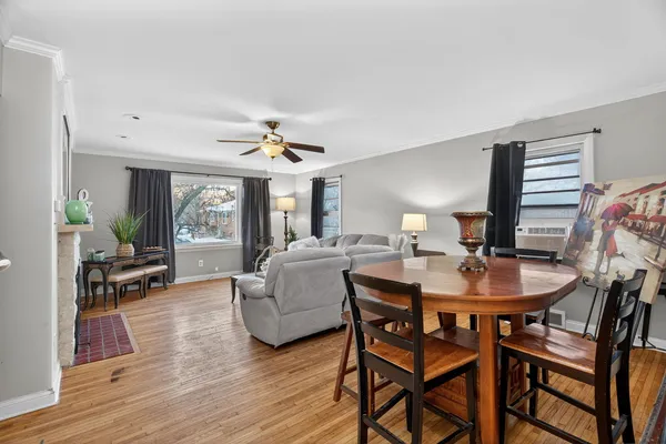 a dining room with furniture and wooden floor