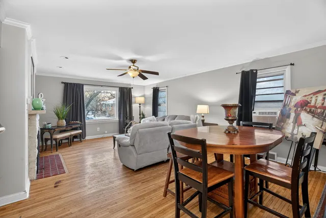 a dining room with furniture and wooden floor