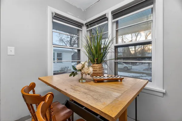 a workspace with furniture bookshelf and a wooden floor