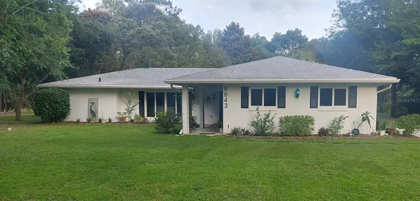 a front view of a house with a garden and porch
