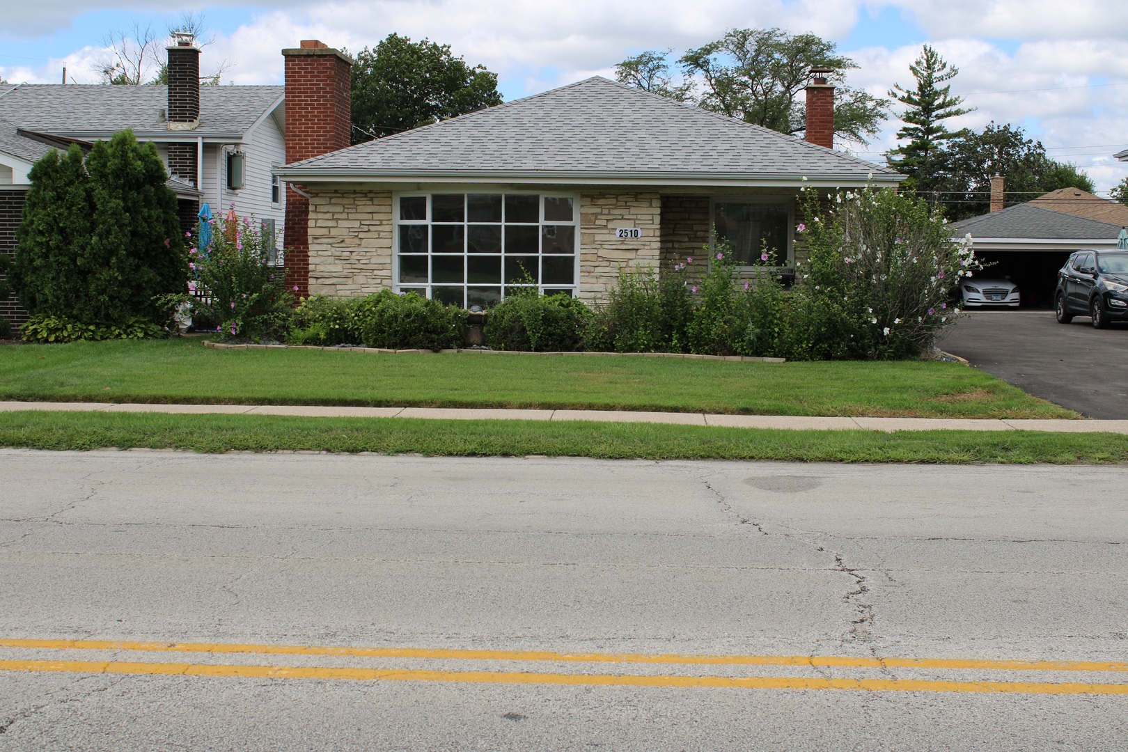 2510 South 17th Avenue Broadview, IL 60155 - Photo 1 of 17 a front view of a house with a yard and potted plants