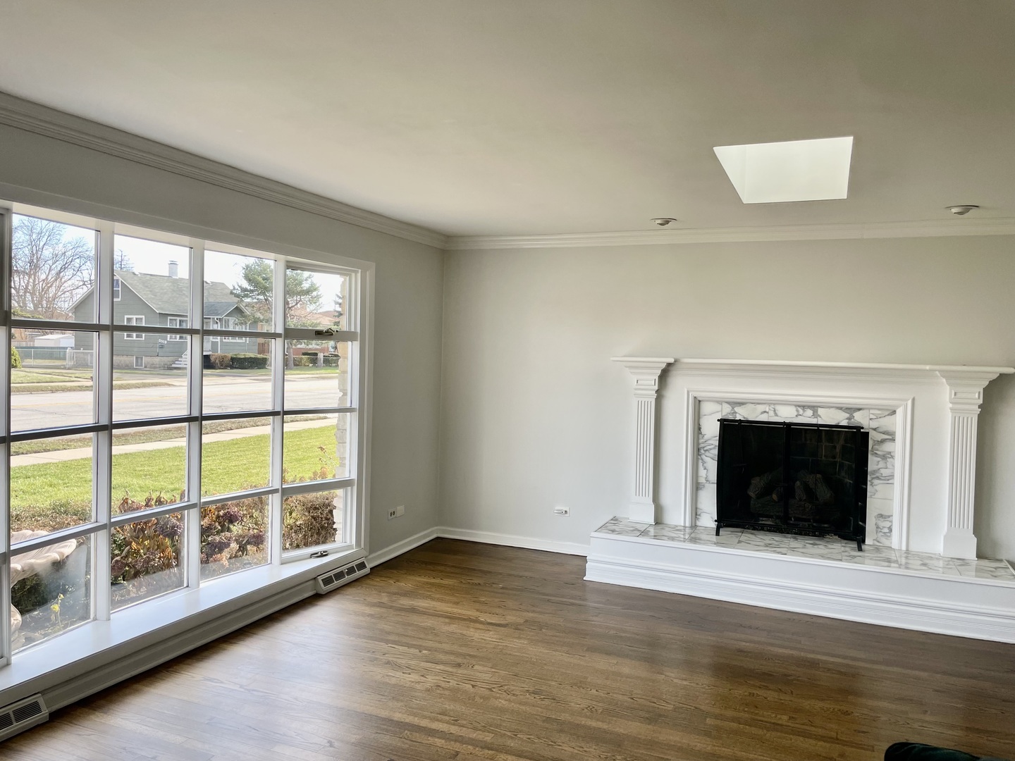 2510 South 17th Avenue Broadview, IL 60155 - Photo 3 of 17 a view of an empty room with wooden floor and a window