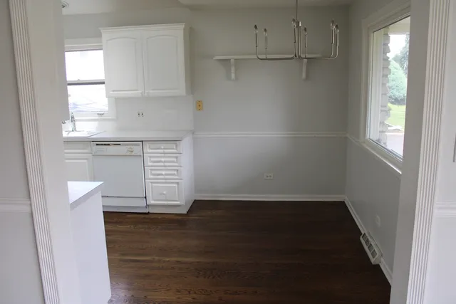a view of kitchen with wooden floor and electronic appliances