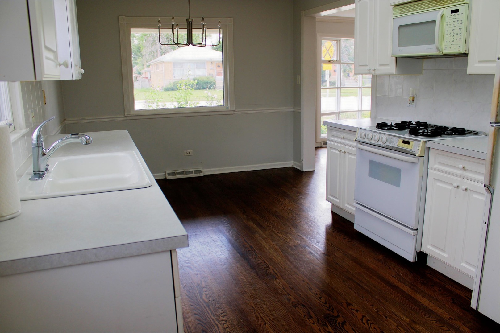 2510 South 17th Avenue Broadview, IL 60155 - Photo 5 of 17 a kitchen with granite countertop white cabinets appliances and a window