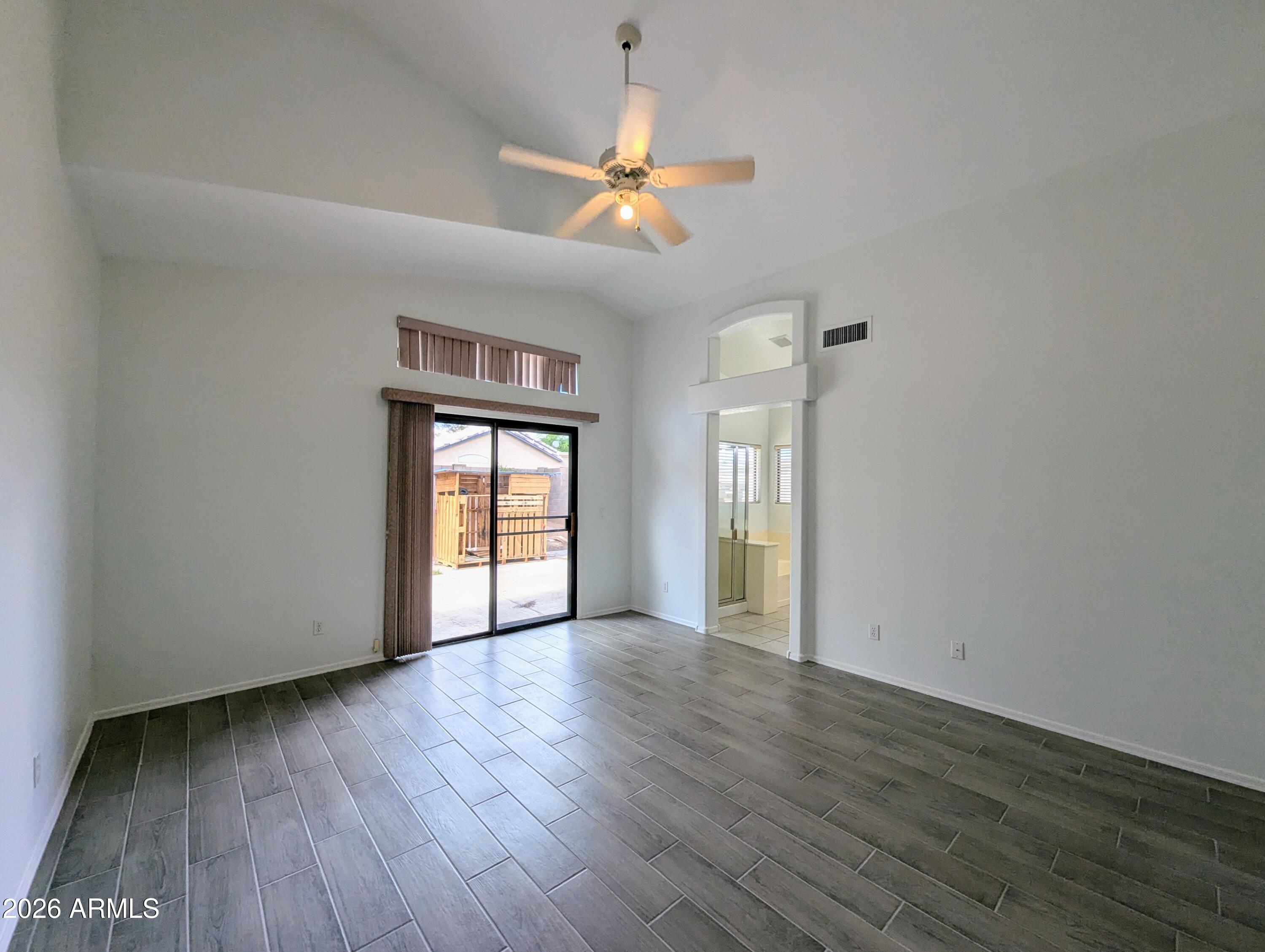 5424 West Wagoner Road Glendale, AZ 85308 - Photo 19 of 37 a view of an empty room with wooden floor and a window