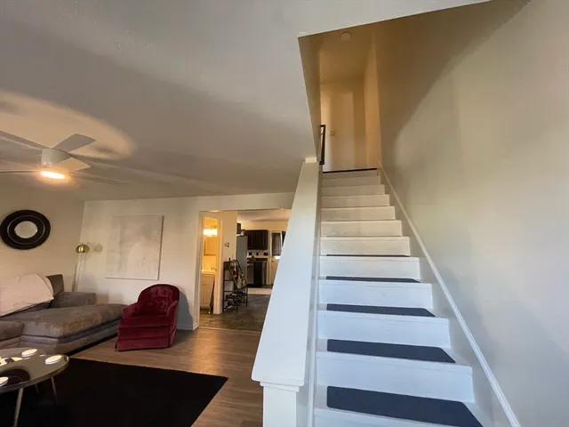 a view of entryway and hall with wooden floor