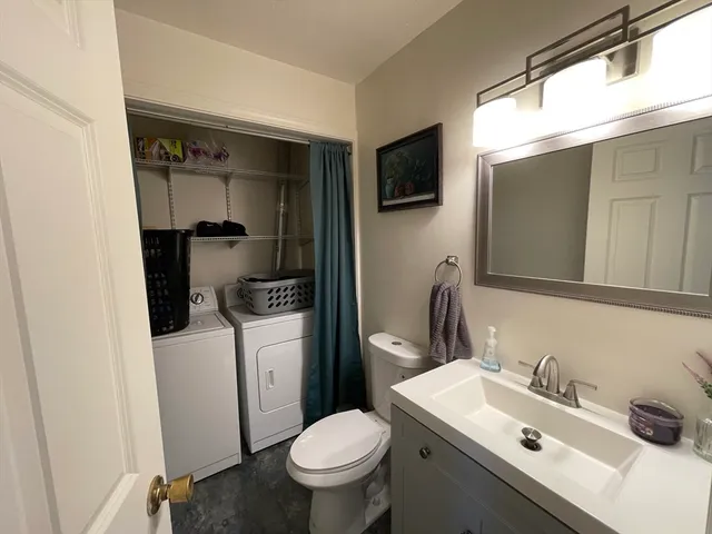 a bathroom with a sink toilet and mirror