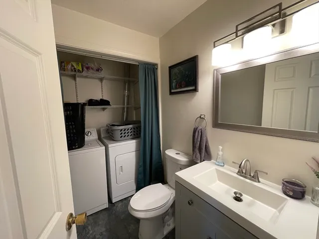 a bathroom with a sink toilet and mirror