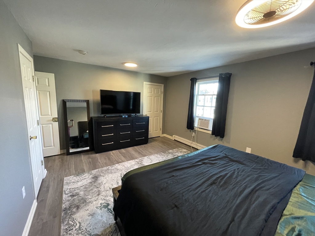 33 Sigel Street, Unit B Worcester, MA 01610 - Photo 16 of 28 a bedroom with a bed and a flat screen tv