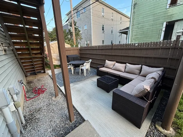 a view of outdoor living space with furniture and rug