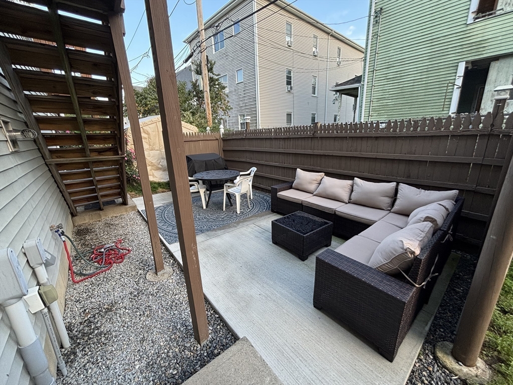 33 Sigel Street, Unit B Worcester, MA 01610 - Photo 5 of 28 a view of outdoor living space with furniture and rug