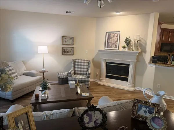 a living room with furniture flat screen tv and a fireplace