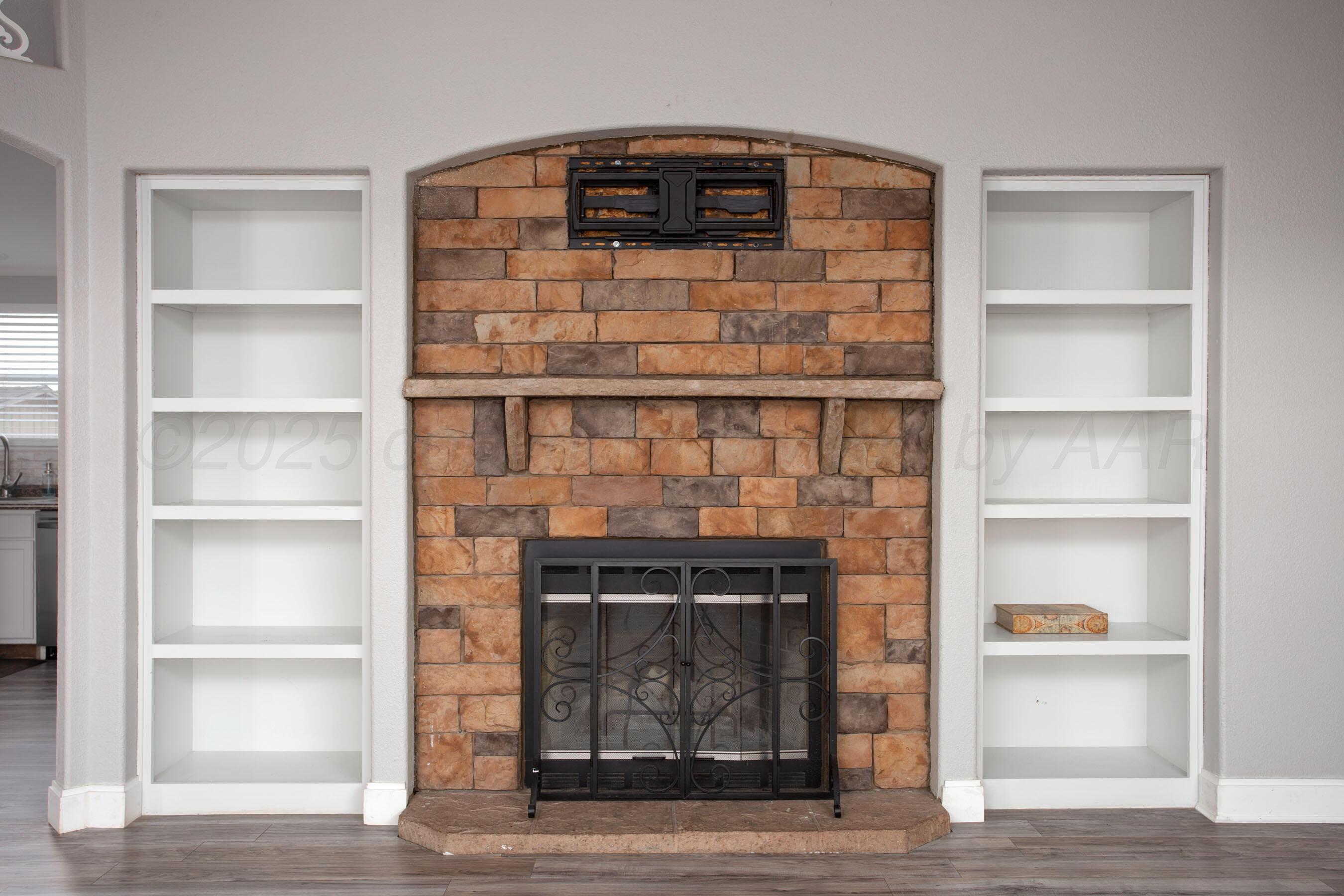 11000 Fox Street Amarillo, TX 79118 - Photo 11 of 40 a living room with a wooden floor and a fireplace
