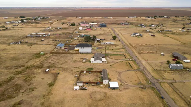 an aerial view of residential houses with outdoor space