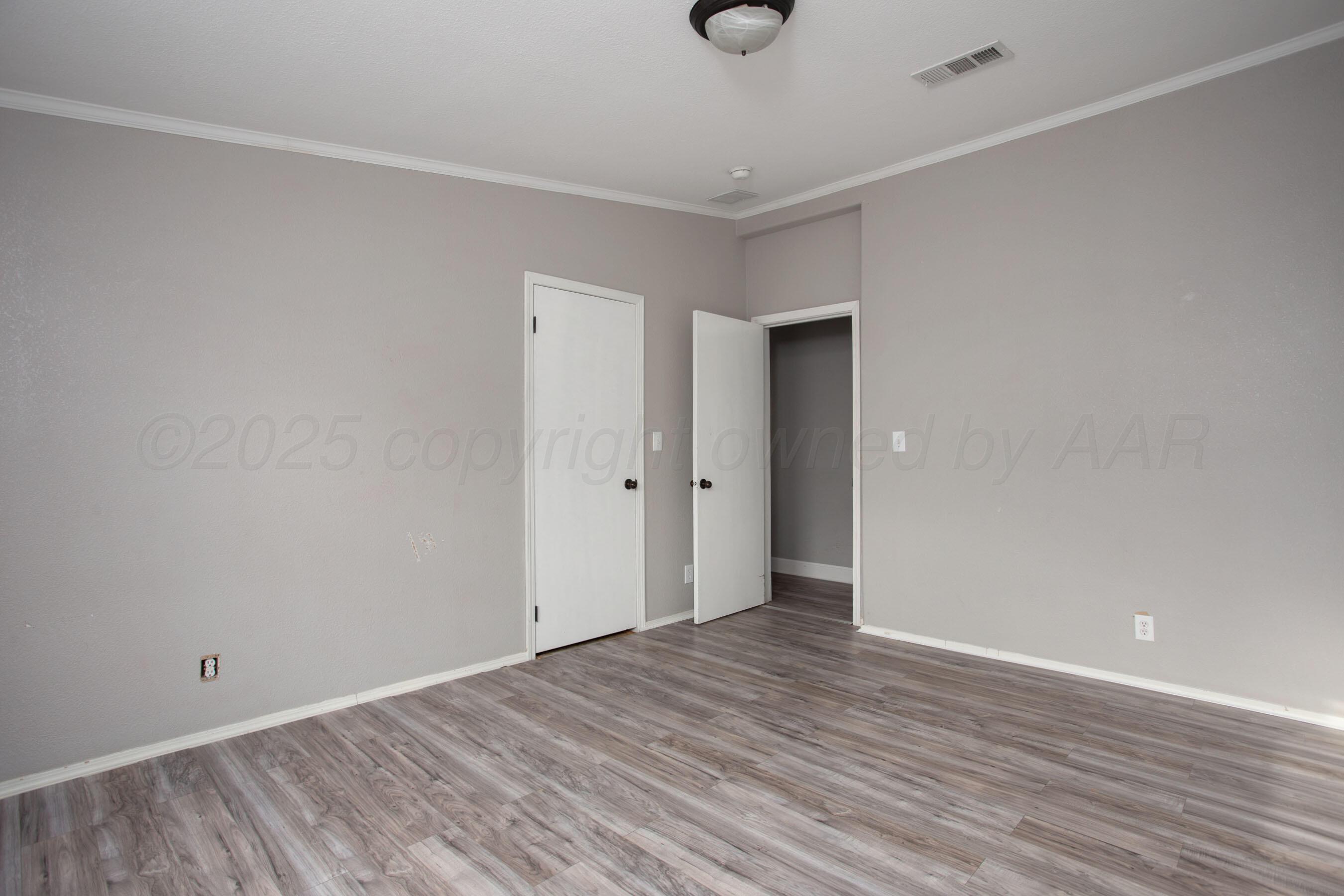 11000 Fox Street Amarillo, TX 79118 - Photo 20 of 40 a view of an empty room with wooden floor