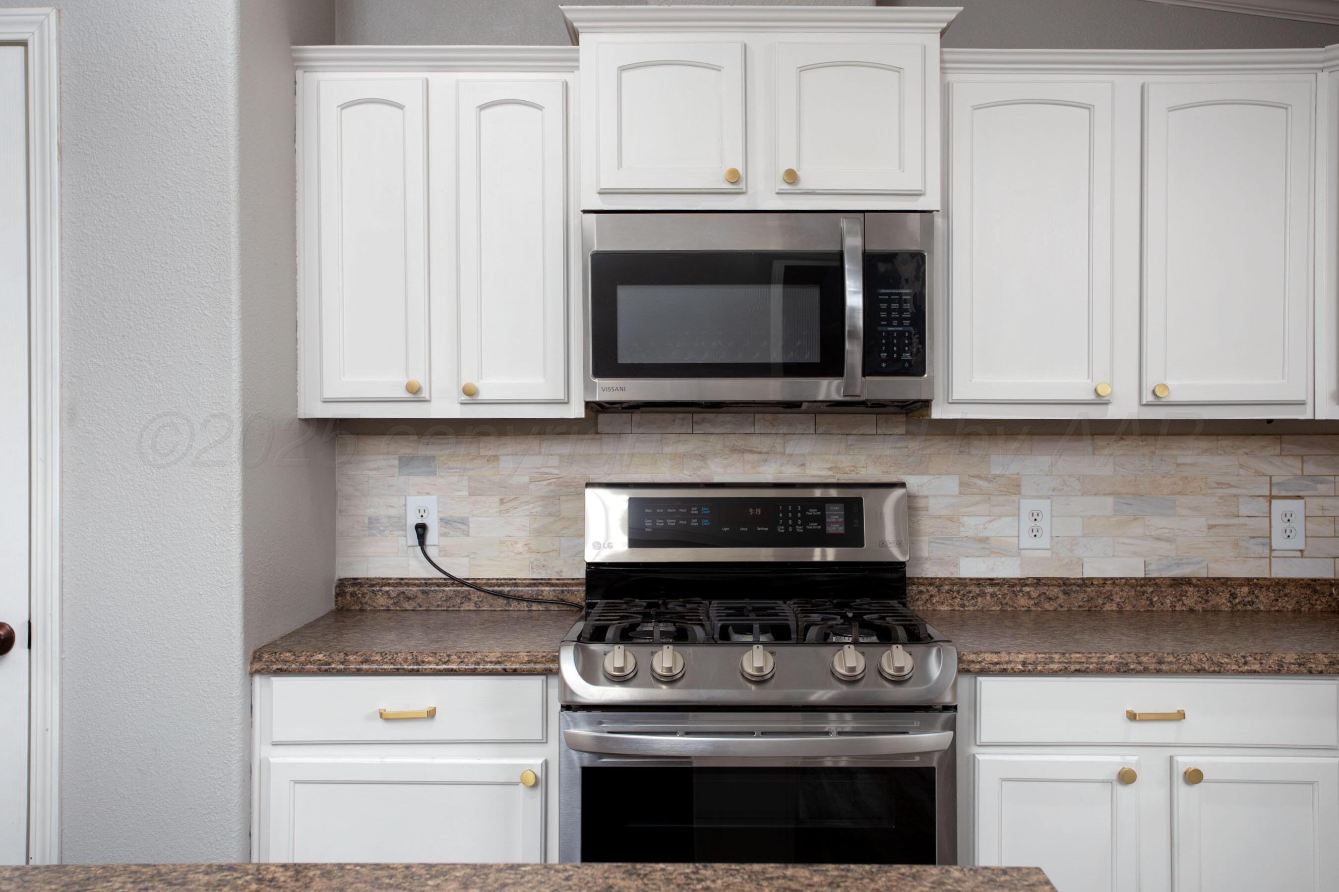 11000 Fox Street Amarillo, TX 79118 - Photo 24 of 40 a kitchen with stainless steel appliances granite countertop white cabinets a stove a sink and dishwasher