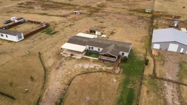 an aerial view of residential houses with outdoor space