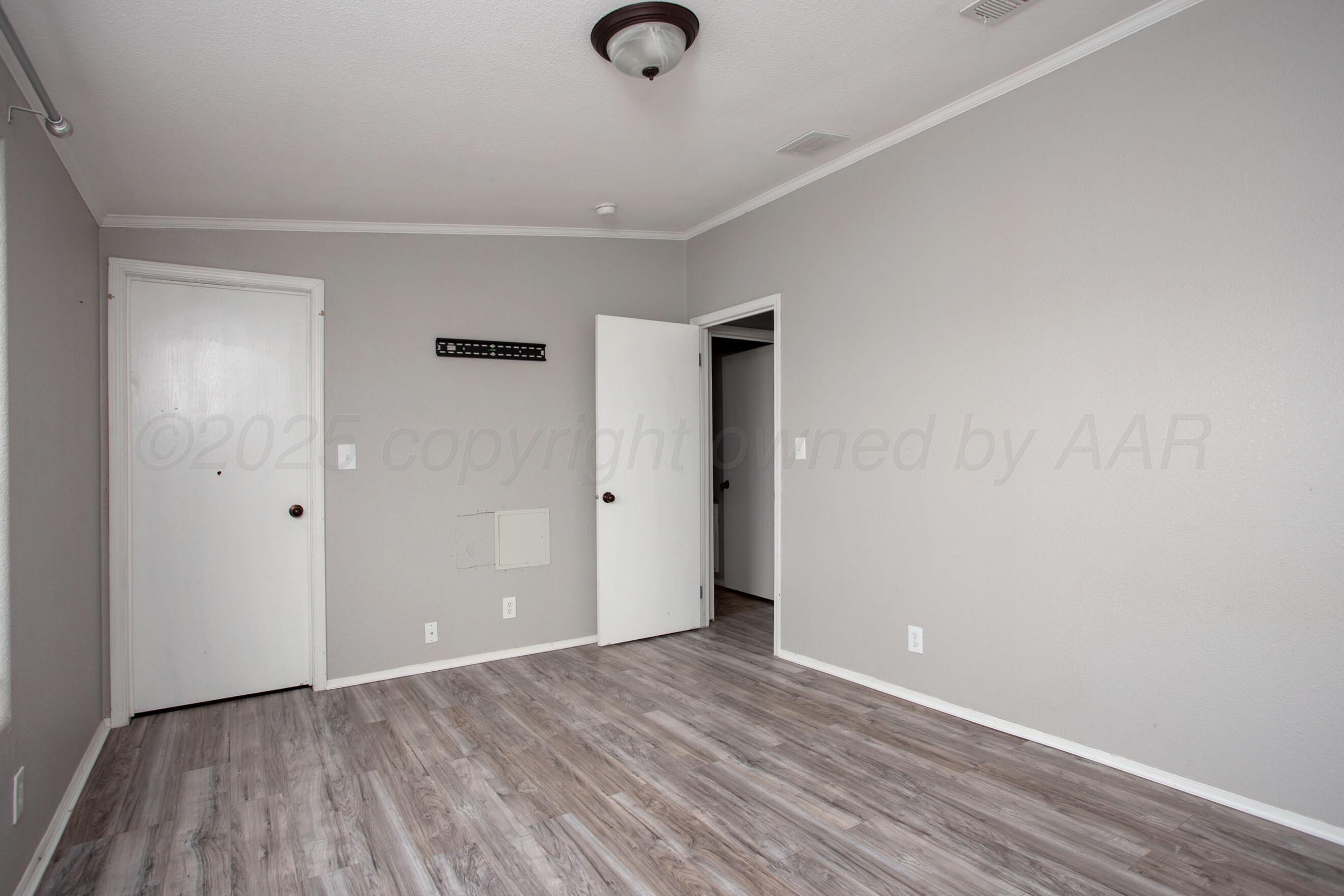 11000 Fox Street Amarillo, TX 79118 - Photo 38 of 40 a view of an empty room with wooden floor and a ceiling fan