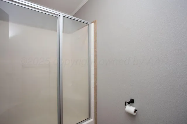 a bathroom with a shower and mirror
