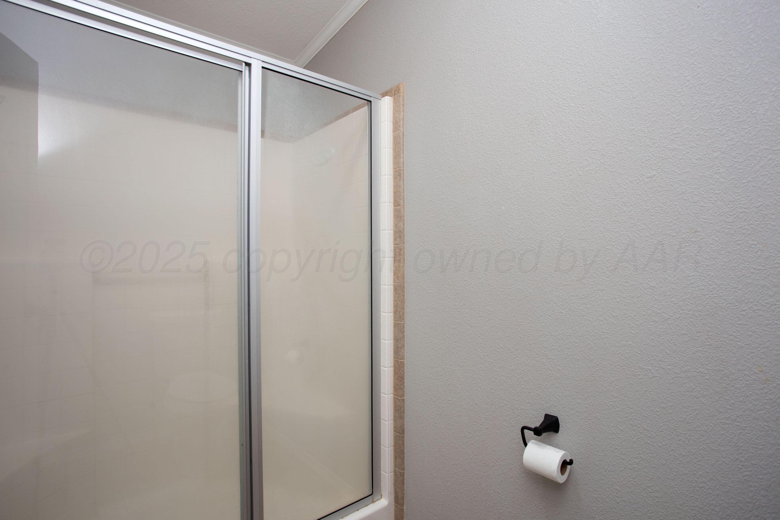 11000 Fox Street Amarillo, TX 79118 - Photo 6 of 40 a bathroom with a shower and mirror