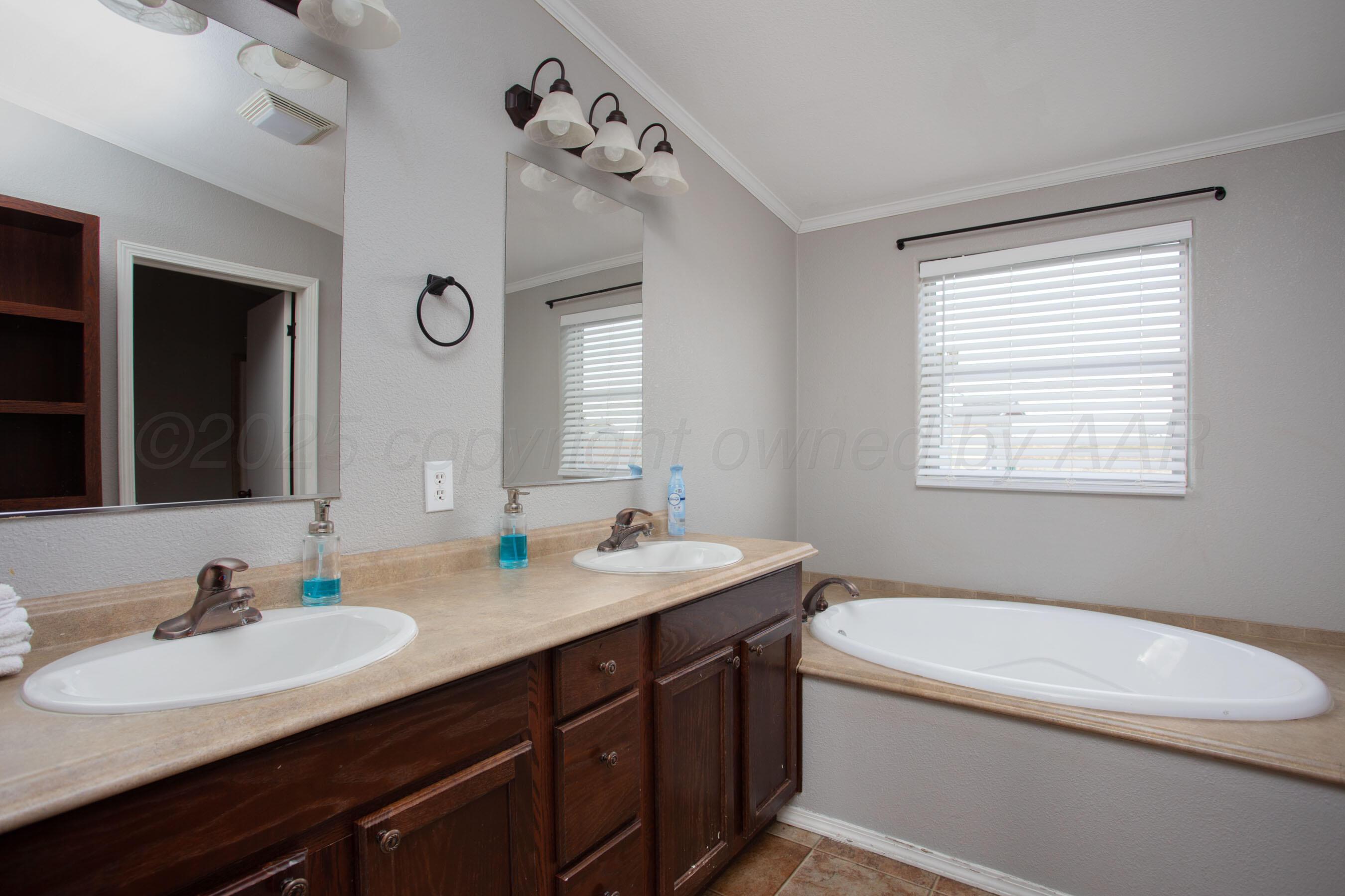 11000 Fox Street Amarillo, TX 79118 - Photo 8 of 40 a bathroom with a granite countertop sink mirror and a toilet