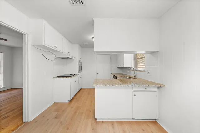 a utility room with cabinets washer and dryer