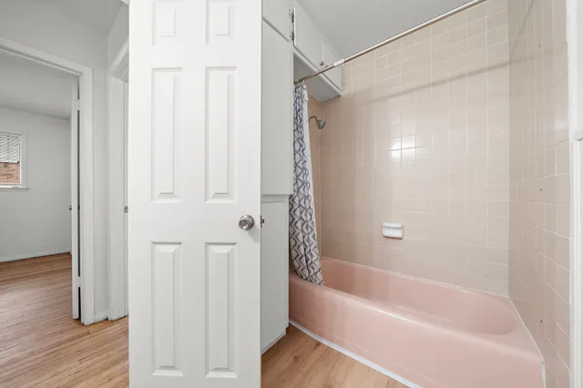 a bathroom with a bathtub and a shower