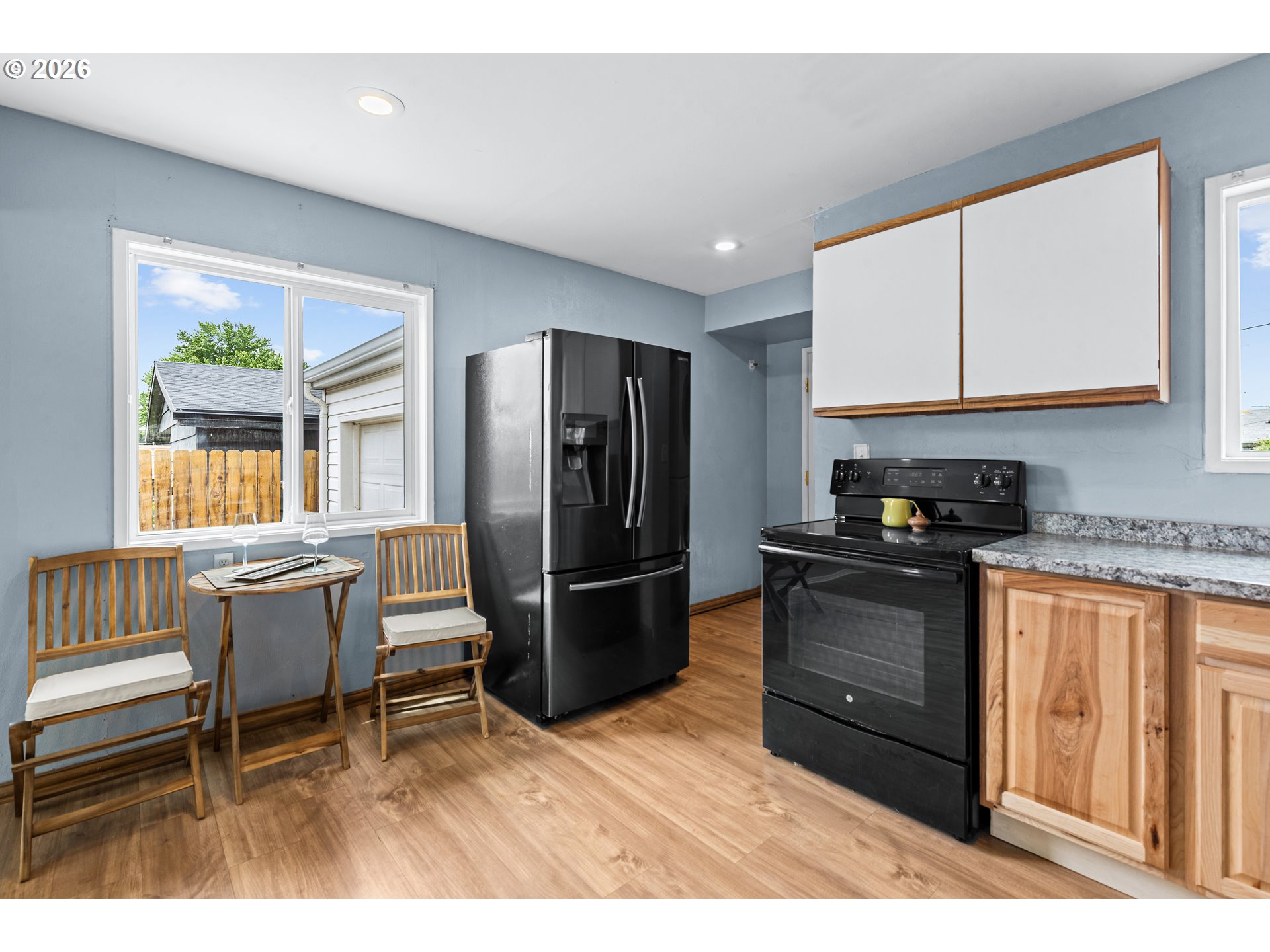 3009 Southwest Isaac Avenue Pendleton, OR 97801 - Photo 12 of 28 a kitchen with a refrigerator and a wooden cabinets