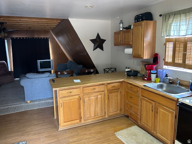 45720 Airport Road Fruitland, UT 84027 - Photo 22 of 22 Kitchen featuring a peninsula, light countertops, light wood-type flooring, open floor plan, and range with electric stovetop