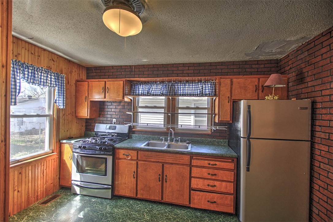 2549 East Main Street Decatur, IL 62521 - Photo 4 of 12 a kitchen with granite countertop stainless steel appliances a refrigerator stove and sink