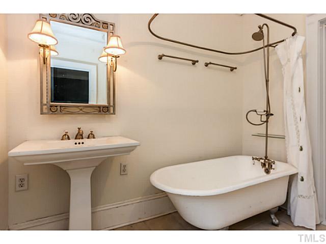 1519 Hanover Street Raleigh, NC 27608 - Photo 13 of 18 a bathroom with a sink a toilet and shower
