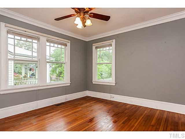 1519 Hanover Street Raleigh, NC 27608 - Photo 14 of 18 an empty room with wooden floor and windows