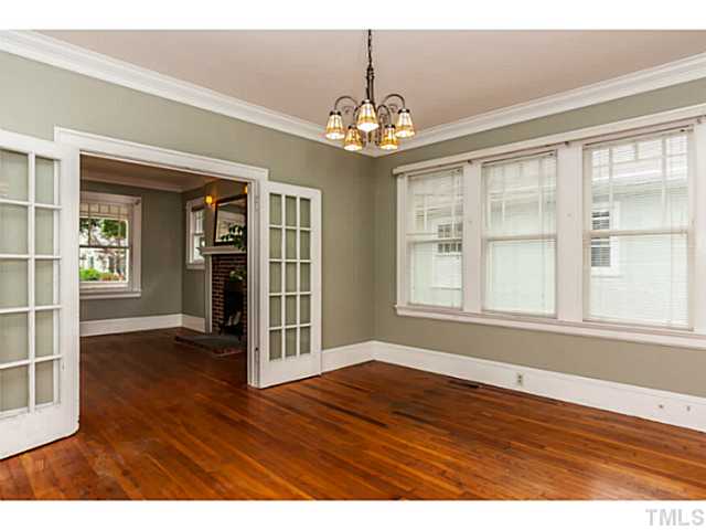 1519 Hanover Street Raleigh, NC 27608 - Photo 6 of 18 a view of an empty room with wooden floor and a window
