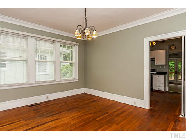 1519 Hanover Street Raleigh, NC 27608 - Photo 7 of 18 a view of an empty room with wooden floor and a window
