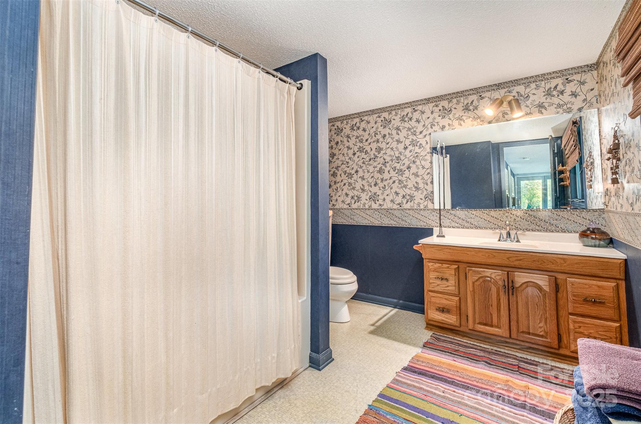1102 Lake Montonia Road Kings Mountain, NC 28086 - Photo 34 of 48 a spacious bathroom with a sink a toilet and a mirror