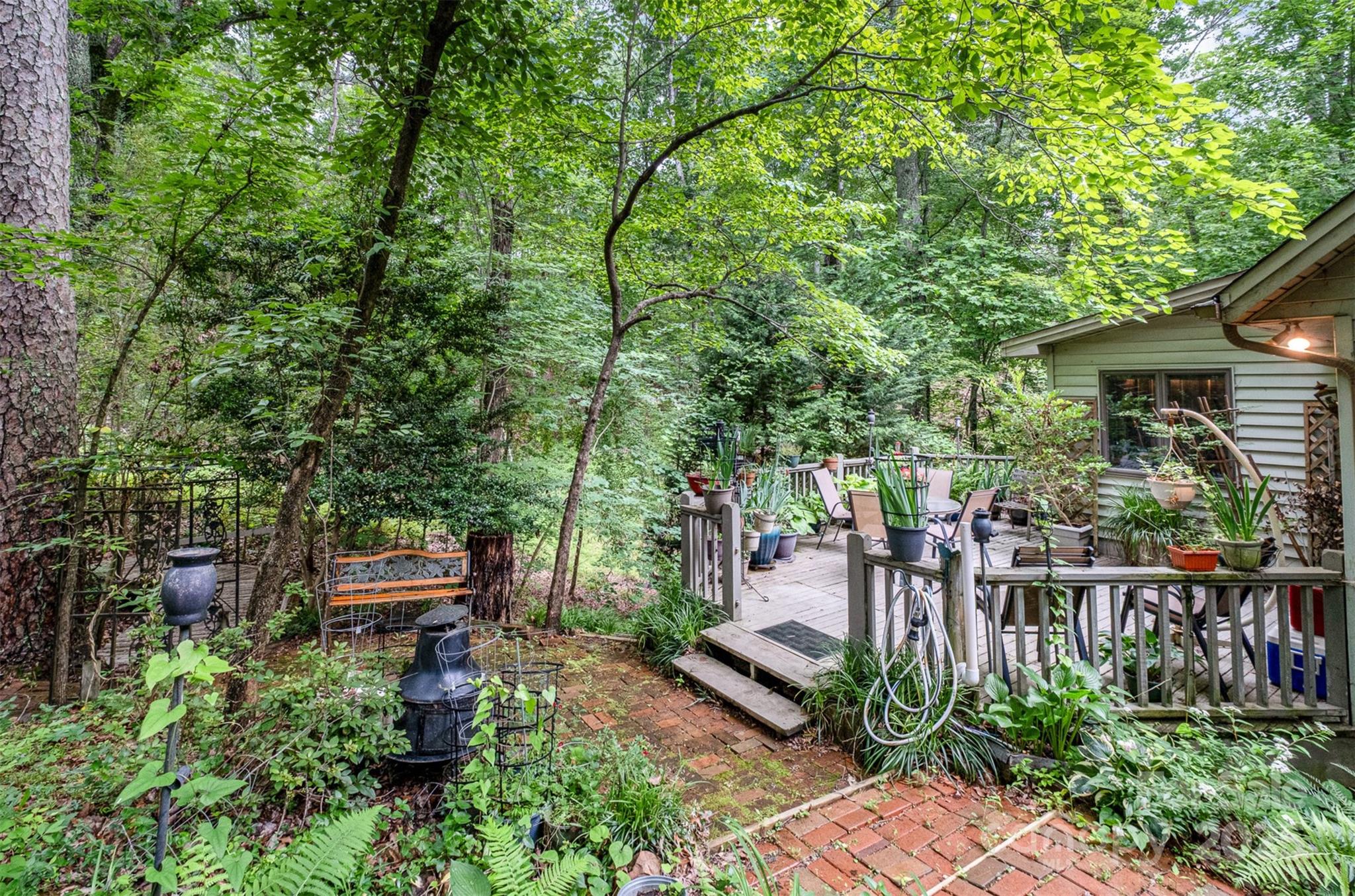 1102 Lake Montonia Road Kings Mountain, NC 28086 - Photo 42 of 48 a view of a deck with couches table and chairs and potted plants