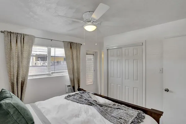 a bedroom with a bed and a window