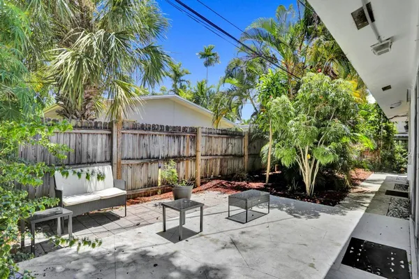 a view of a backyard with sitting area