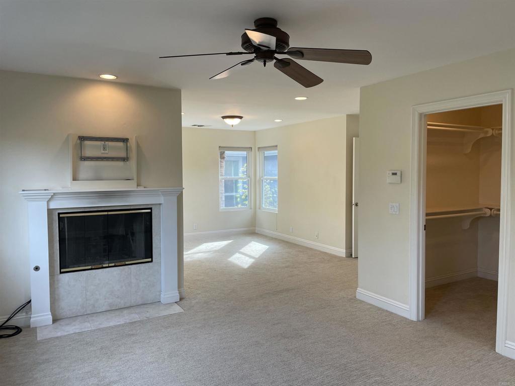 428 La Veta Avenue Encinitas, CA 92024 - Photo 12 of 25 a view of a livingroom with a fireplace and a ceiling fan