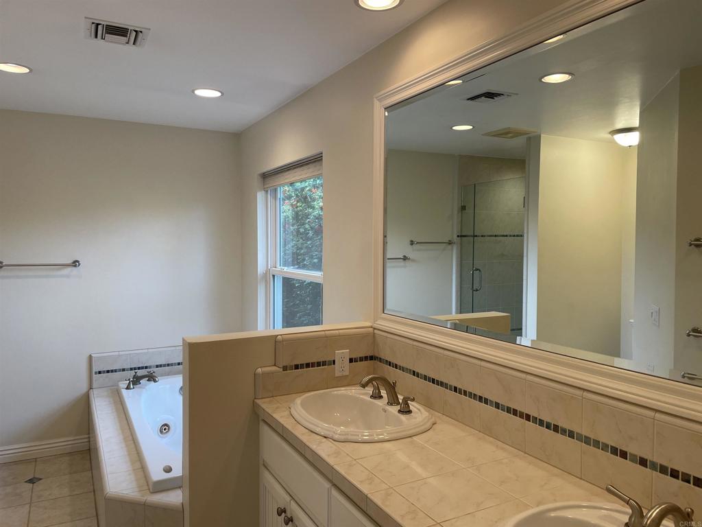 428 La Veta Avenue Encinitas, CA 92024 - Photo 14 of 25 a bathroom with a granite countertop sink and a large mirror
