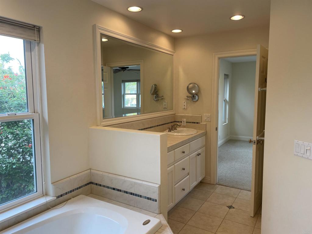 428 La Veta Avenue Encinitas, CA 92024 - Photo 15 of 25 a bathroom with a sink a mirror and a window