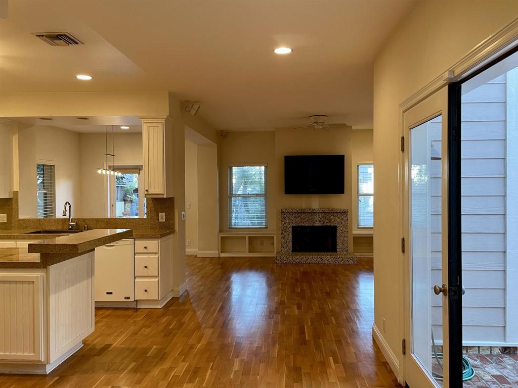 428 La Veta Avenue Encinitas, CA 92024 - Photo 5 of 25 a view of a kitchen with a sink a refrigerator and a stove top oven