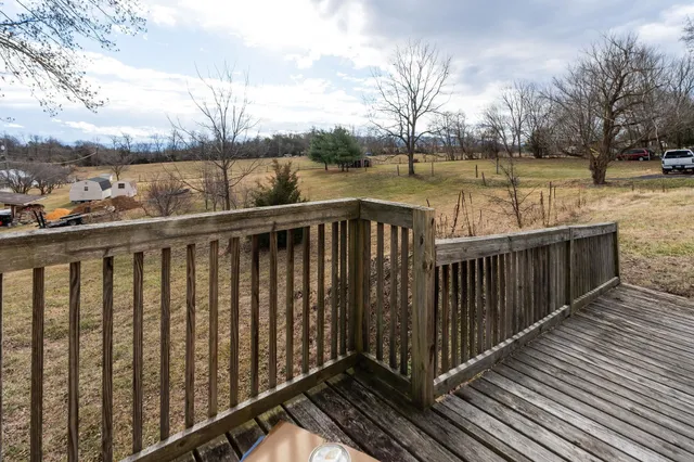 a balcony with wooden floor and lake view
