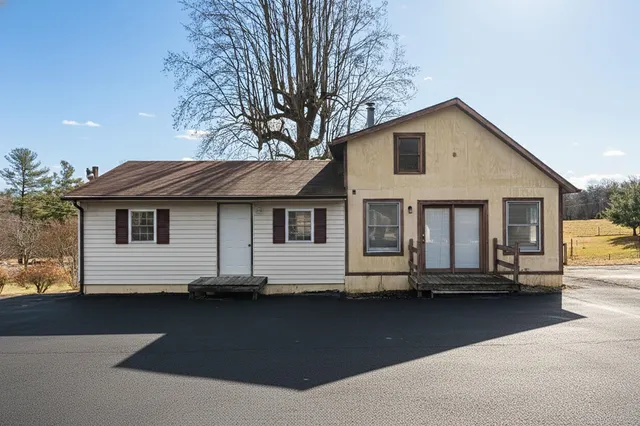 a front view of a house with a road
