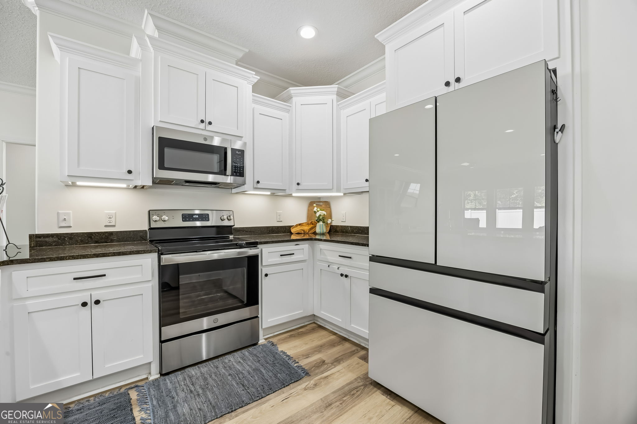 152 Verano Street Kingsland, GA 31548 - Photo 16 of 55 a kitchen with granite countertop white cabinets and stainless steel appliances