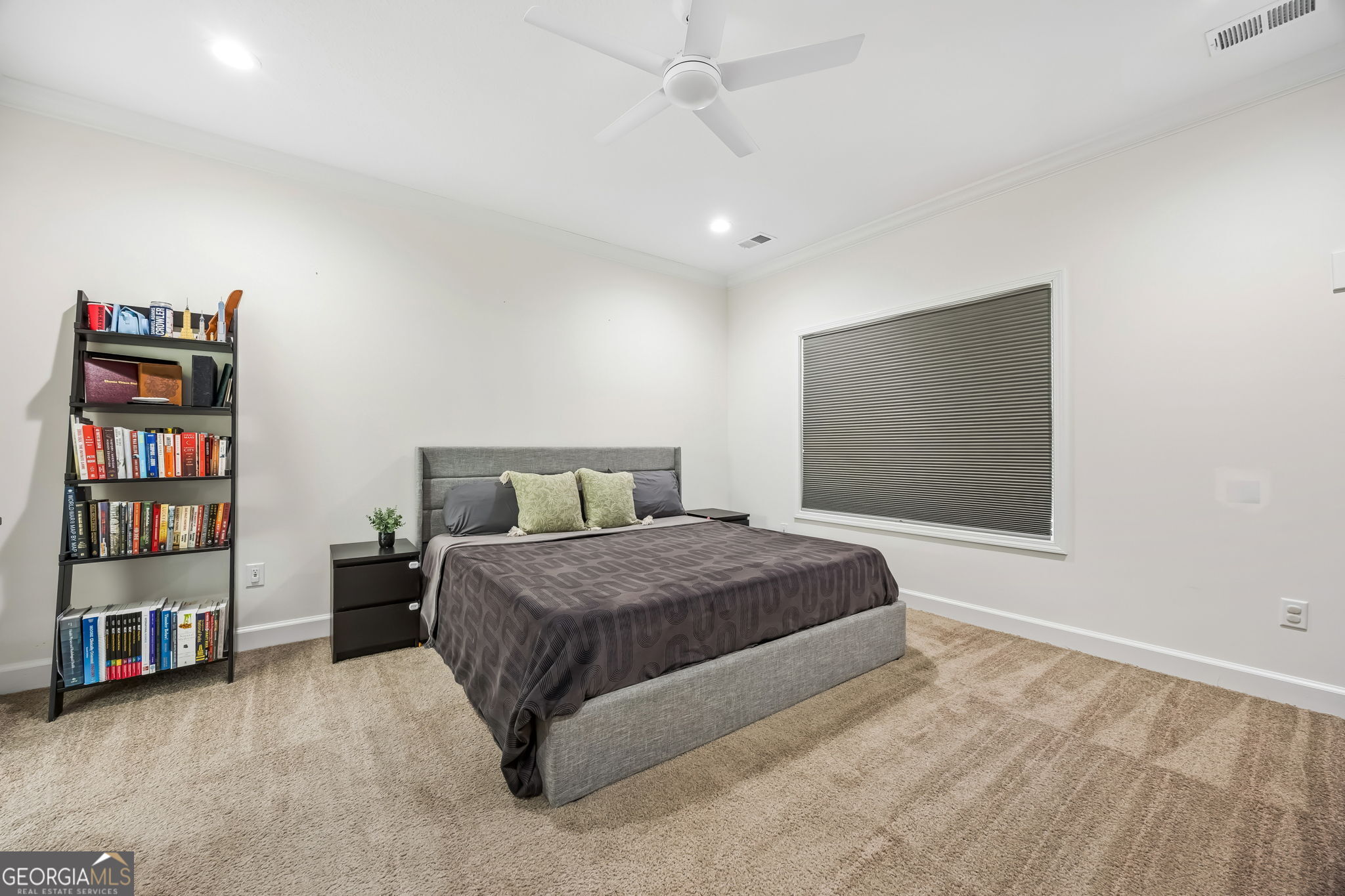 152 Verano Street Kingsland, GA 31548 - Photo 17 of 55 a spacious bedroom with a bed and a book shelf