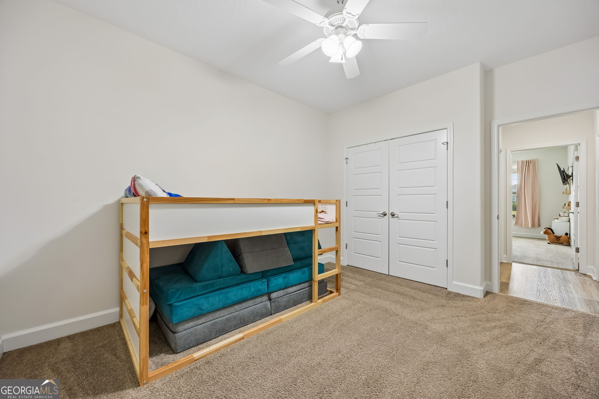 152 Verano Street Kingsland, GA 31548 - Photo 30 of 55 a bedroom with a bed and a chandelier