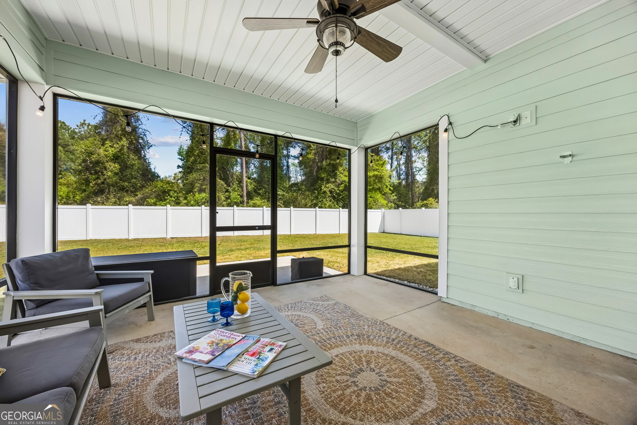152 Verano Street Kingsland, GA 31548 - Photo 34 of 55 a living room with couch and a floor to ceiling window